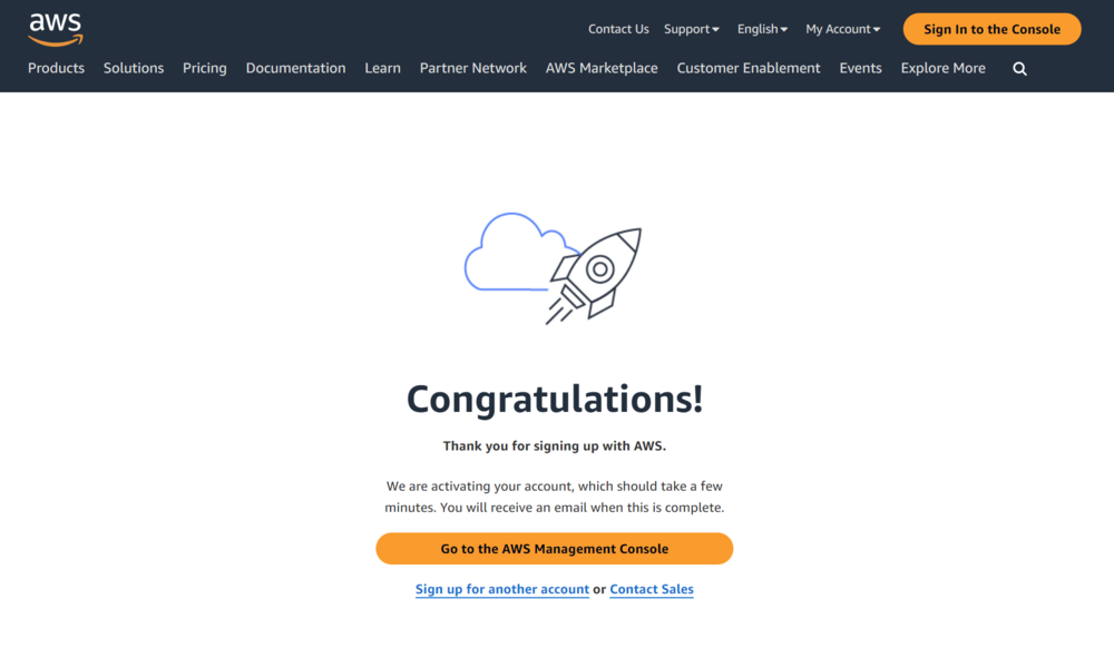 Screenshot of AWS confirmation page with a ‘Congratulations!’ message, indicating successful sign-up and account activation in progress, featuring a cloud and rocket ship graphic